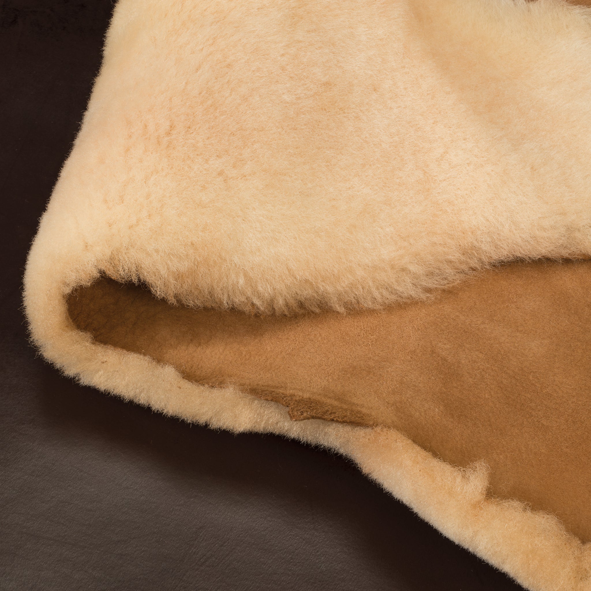 Close-up of beige shearling texture showing plush surface and warm wool tone for home decor